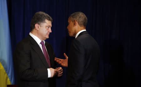 U.S. President Barack Obama meets with Ukraine's President-elect Petro Poroshenko in Warsaw June 4, 2014. Obama promised on Tuesday to beef up military support for eastern European members of the NATO alliance who fear they could be next in the firing line after the Kremlin's intervention in Ukraine. REUTERS/Kevin Lamarque