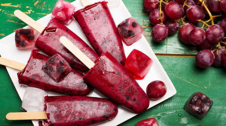 Grape popsicles on a green table