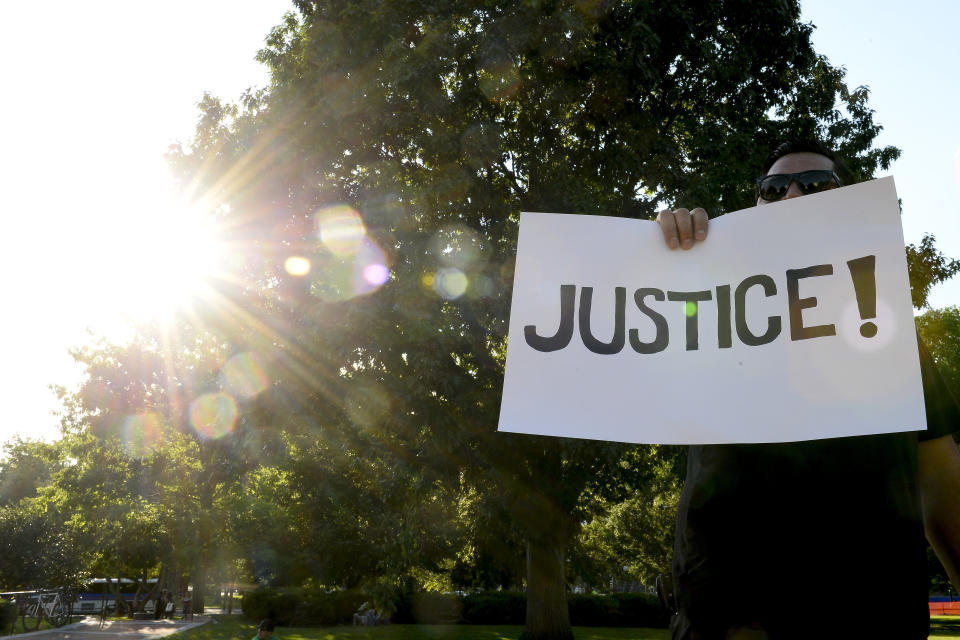 A protester holds a sign in Denver, Colorado.