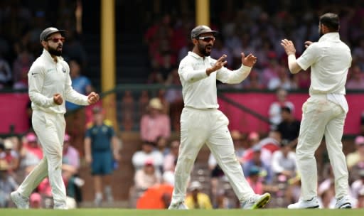 India's Ajinkya Rahane (C) is congratulated by bowler Ravindra Jadeja after catching Australia's batsman Marnus Labuschagne out, as captain Virat Kohli celebrates, on the third day of their fourth and final Test match, in Sydney, on January 5, 2019