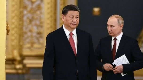 PHOTO: Russian President Vladimir Putin and China's President Xi Jinping enter a hall during a meeting at the Kremlin in Moscow on March 21, 2023. (Alexey Maishev/SPUTNIK/AFP via Getty Images)