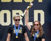 Jul 7, 2015; Los Angeles, CA, USA; United States defender Christie Rampone (right) hoists the FIFA World Cup trophy flanked by forward Abby Wambach at 2015 Womens World Cup champions celebration at Microsoft Square at L.A. Live. Mandatory Credit: Kirby Lee-USA TODAY Sports