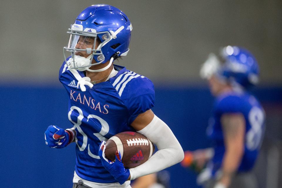 Kansas redshirt sophomore wide receiver Quentin Skinner (83) runs through drills during practice one evening earlier this fall inside the indoor practice facility.