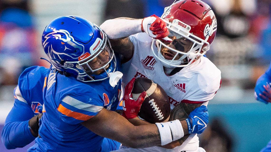 Boise State safety Rodney Robinson tackles Fresno State wide receiver Nikko Remigio during the Mountain West Championship, Saturday, Dec. 3, 2022, at Albertsons Stadium in Boise.