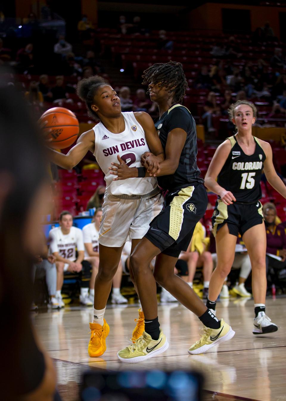 ASU's Jaddan Simmons passes the ball as Colorado's Mya Hollingshed attempts to block her during a game at Desert Financial Arena in Tempe on Jan. 21, 2022.