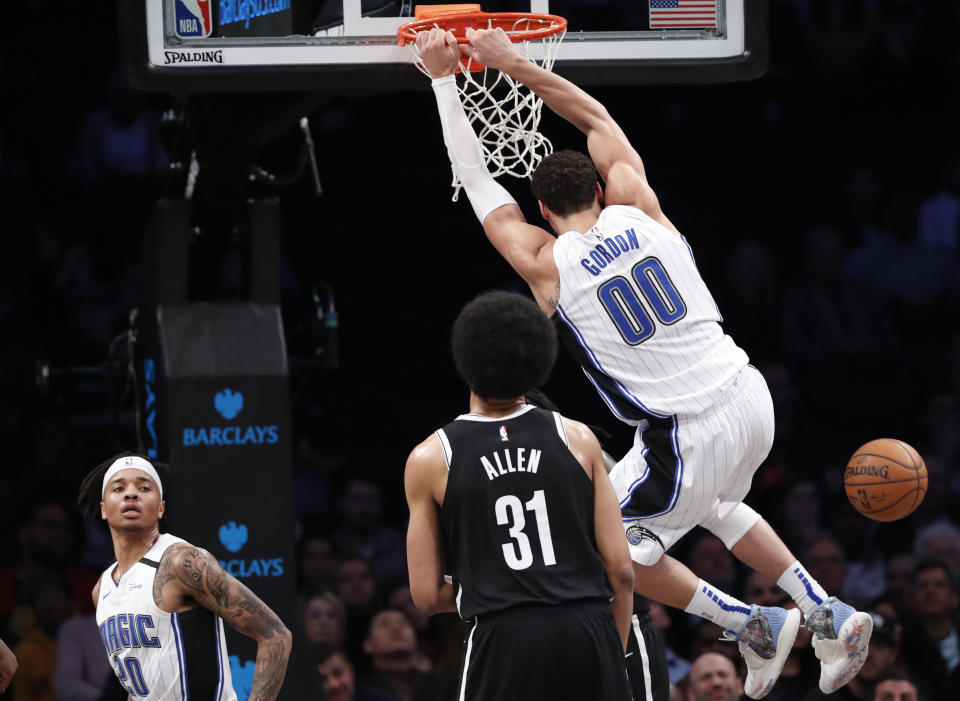 Orlando Magic guard Markelle Fultz (20) watches as Magic forward Aaron Gordon (00) dunks in front of Brooklyn Nets center Jarrett Allen (31) during the second quarter of an NBA basketball game, Monday, Feb. 24, 2020, in New York. (AP Photo/Kathy Willens)