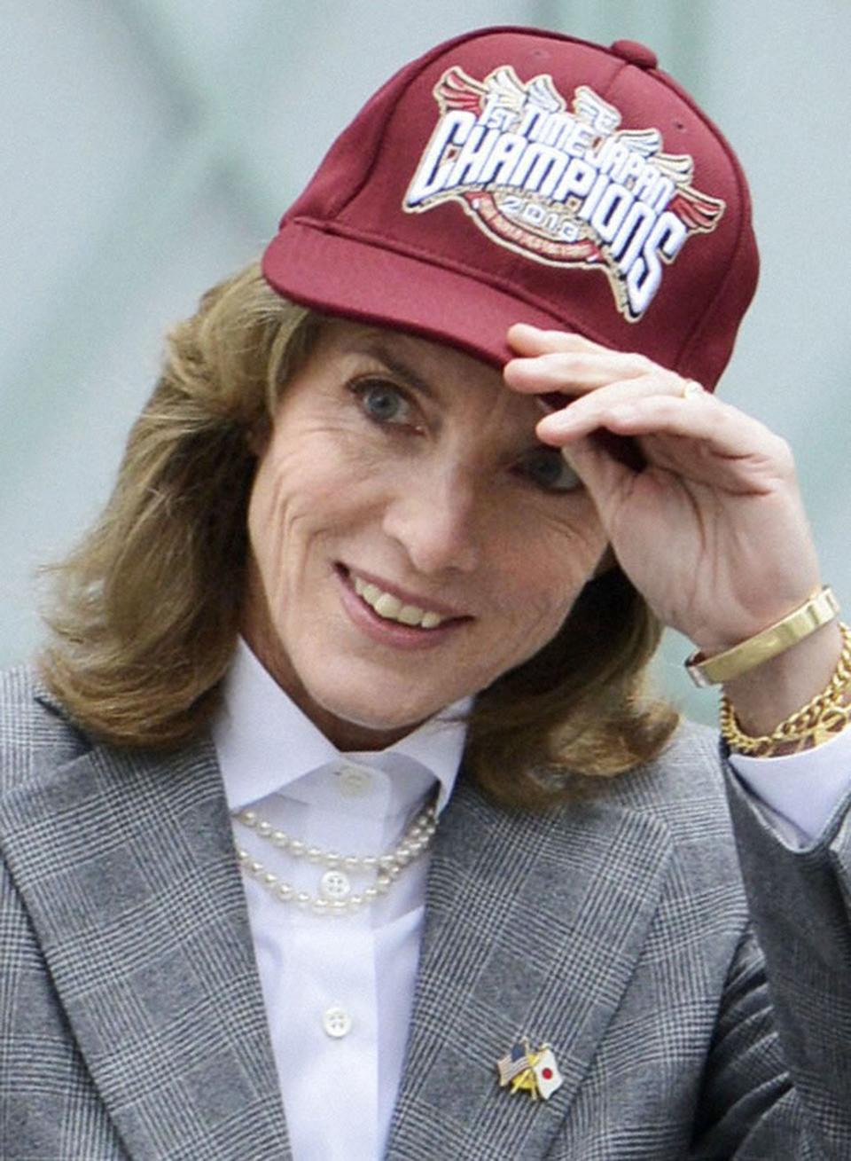 New U.S. Ambassador to Japan Caroline Kennedy puts on a cap of Rakuten Golden Eagles baseball team cap as she poses for a photo during her visit in Sendai, Japan
