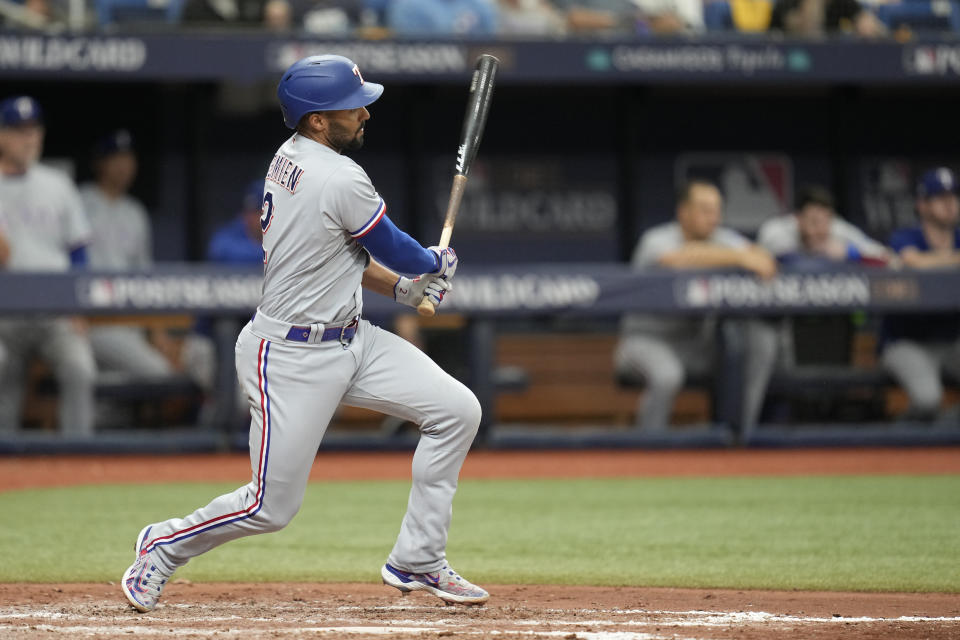 Texas Rangers' Marcus Semien hits a double scoring Josh Jung in the sixth inning of Game 2 in an AL wild-card baseball playoff series against the Tampa Bay Rays, Wednesday, Oct. 4, 2023, in St. Petersburg, Fla. (AP Photo/John Raoux)