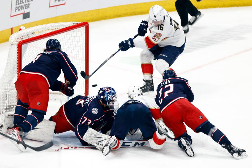 Florida Panthers forward Aleksander Barkov (16) scores past Columbus Blue Jackets defenseman Ivan Provorov, left, goalie Jet Greaves (73), defenseman Jake Bean (22) and Panthers forward Sam Bennett, second from front right, during the third period of an NHL hockey game in Columbus, Ohio, Sunday, Dec. 10, 2023. (AP Photo/Paul Vernon)