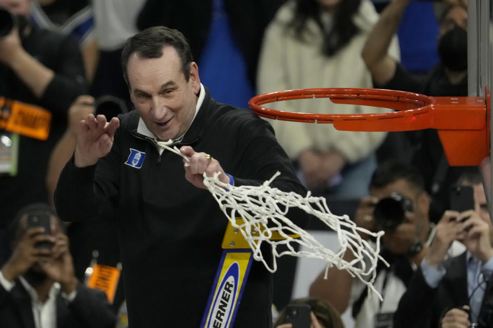 Duke head coach Mike Krzyzewski celebrates while cutting down the net after Duke defeated Arkansas in a college basketball game in the Elite 8 round of the NCAA men's tournament in San Francisco, Saturday, March 26, 2022. (AP Photo/Tony Avelar)