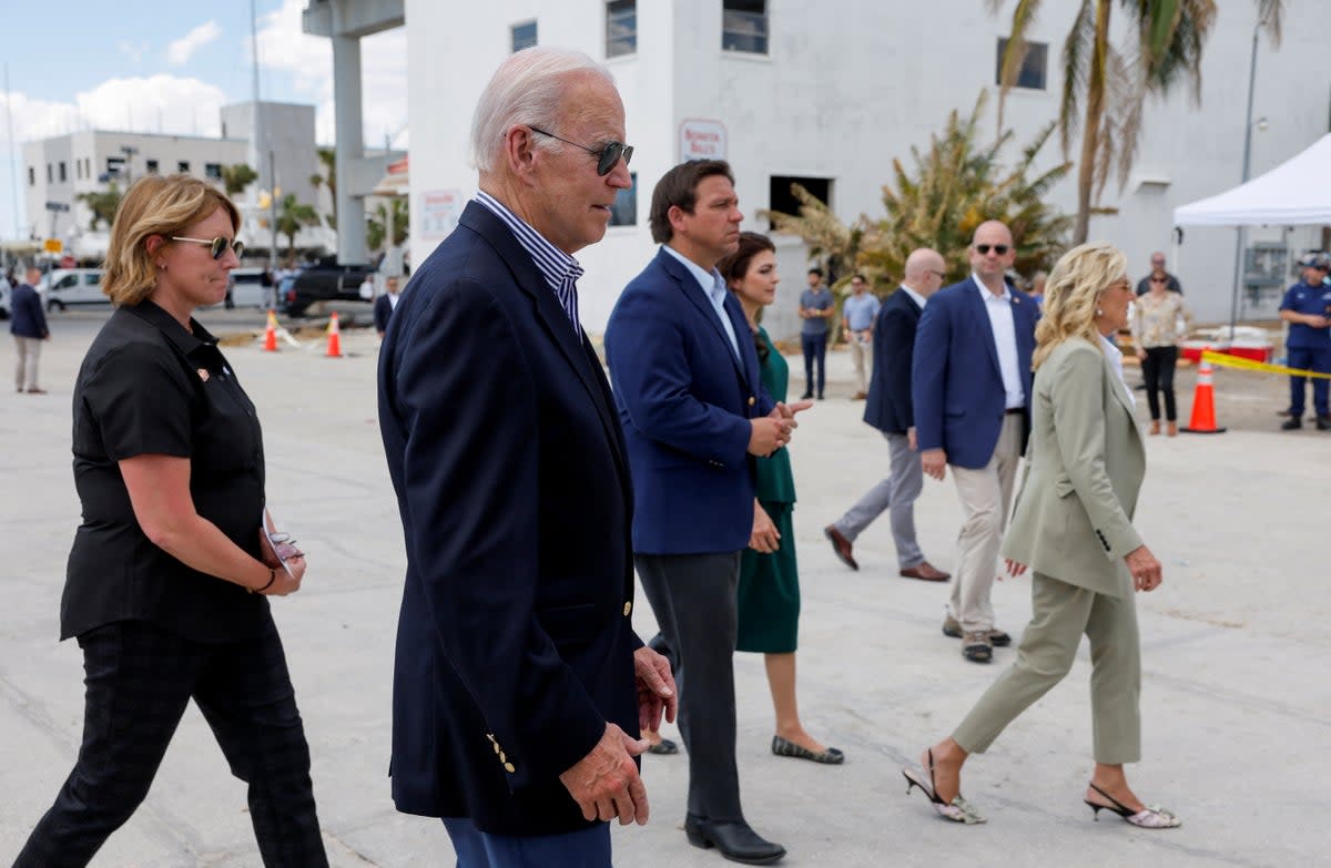 President Joe Biden and first lady Jill Biden walk next to Florida governor Ron DeSantis and his wife Casey DeSantis as they tour Hurricane Ian destruction during a visit to Florida (REUTERS)