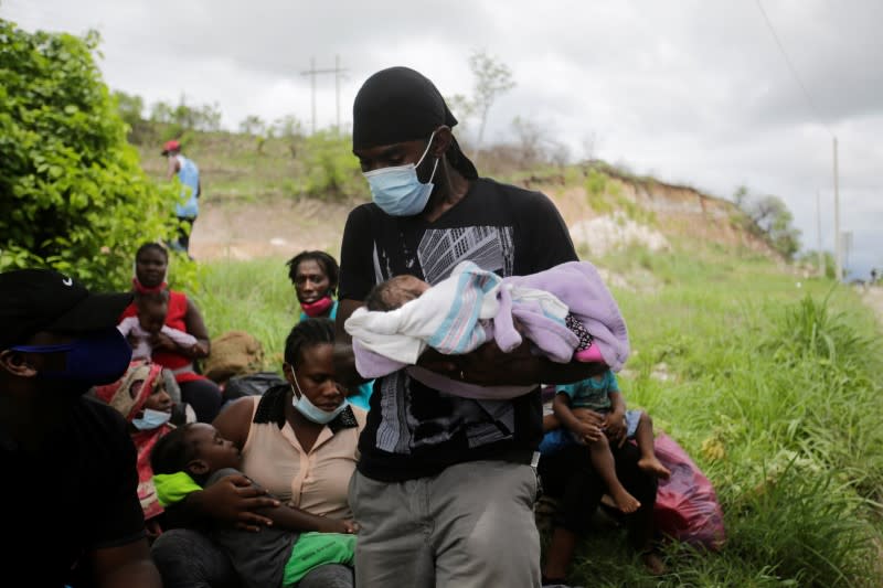 African, Cuban and Haitian migrants, which are stranded in Honduras after borders were closed due to the coronavirus disease (COVID-19) outbreak, rest while trekking northward in an attempt to reach the United States, in Choluteca