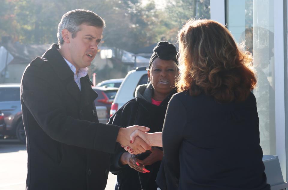 Hattiesburg, Miss., Mayor Toby Barker, left, shakes hands with ALDI Divisional Vice President Heather Moore, right, at the opening of new ALDI in Hattiesburg Thursday, Dec. 7, 2023.