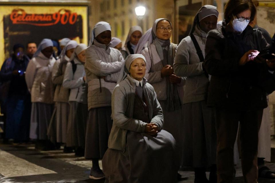 People queue at St Peter's Square on January 3 (REUTERS)