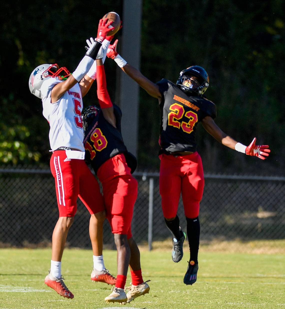 Southwest receiver Dejuandre Riggins (5) hauls in a deep pass over Northeast defenders during their game Friday night.