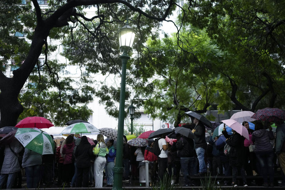 State workers, some who have been laid off, gather outside the Ministry of Human Capital and Health, in Buenos Aires, Argentina, Wednesday, April 3, 2024. According to the State Workers Association, more than 11 thousand dismissals of state employees have been carried out by Javier Milei’s government. The union is calling for massive and simultaneous re-entry of dismissed individuals. (AP Photo/Natacha Pisarenko)