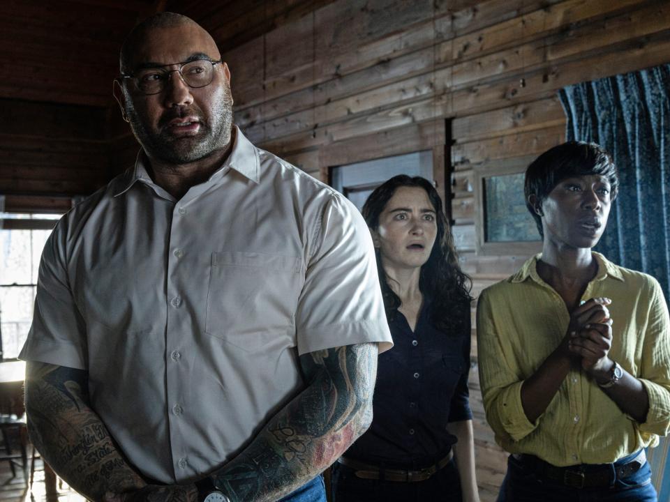 Dave Bautista standing in a cabin