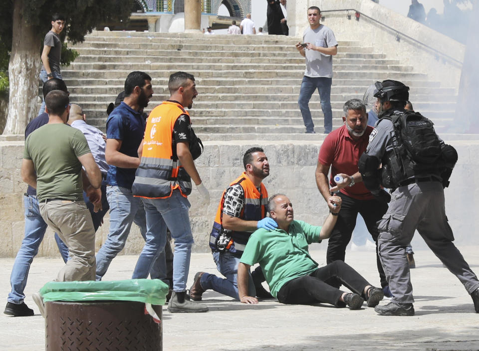 Israeli police clears Palestinians from the plaza in front of the Dome of the Rock shrine at al-Aqsa mosque complex in Jerusalem, Friday, May 21, 202, as aa cease-fire took effect between Hamas and Israel after 11-day war. (AP Photo/Mahmoud Illean)