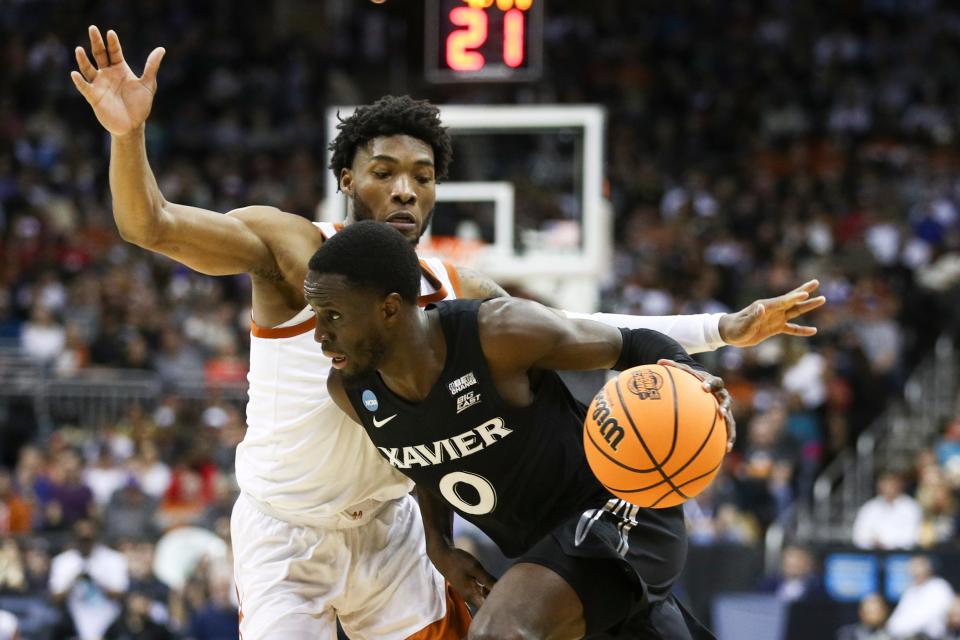 Texas' Tyrese Hunter defends Xavier guard Souley Boum as Boum tries to drive against him during the first half Friday night. The Longhorns are now 29-8 and will play in the program's first Elite Eight game since the 2008 NCAA Tournament.