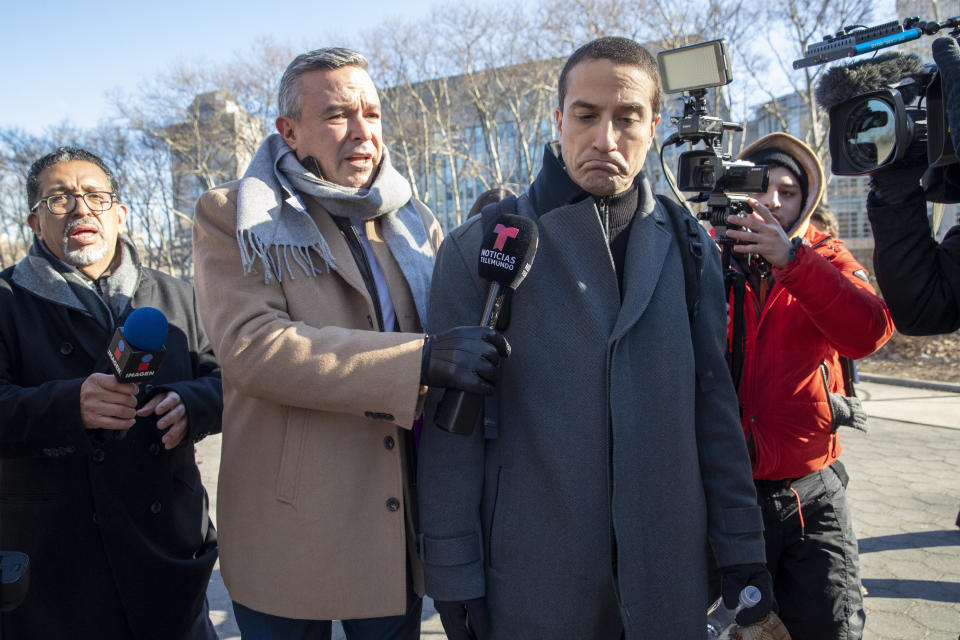 Cesar De Castro, center, attorney for Genaro Garcia Luna, Mexico's former top security official, is surrounded by reporters as he leaves Federal court in Brooklyn, Tuesday, Jan. 21, 2020, in New York. (AP Photo/Mary Altaffer)