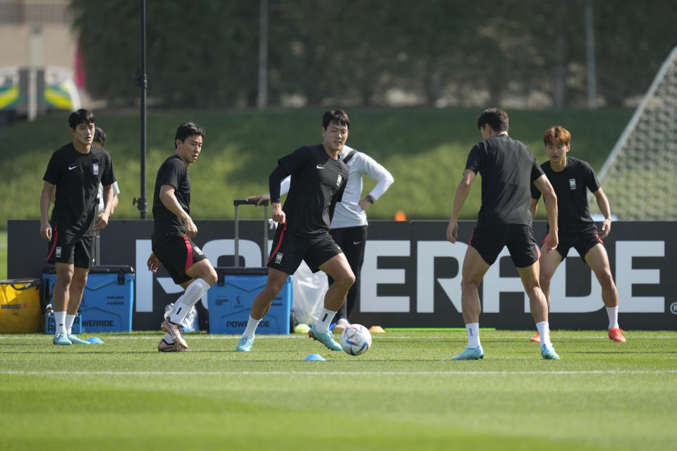 South Korea's Kim Young-gwon, third from left, warms up during the South Korea's official training on the eve of the World Cup round of 16 soccer match between Brazil and South Korea at the Al Egla Training Site 5 in Doha, Qatar, Sunday, Dec. 4, 2022. (AP Photo/Lee Jin-man)