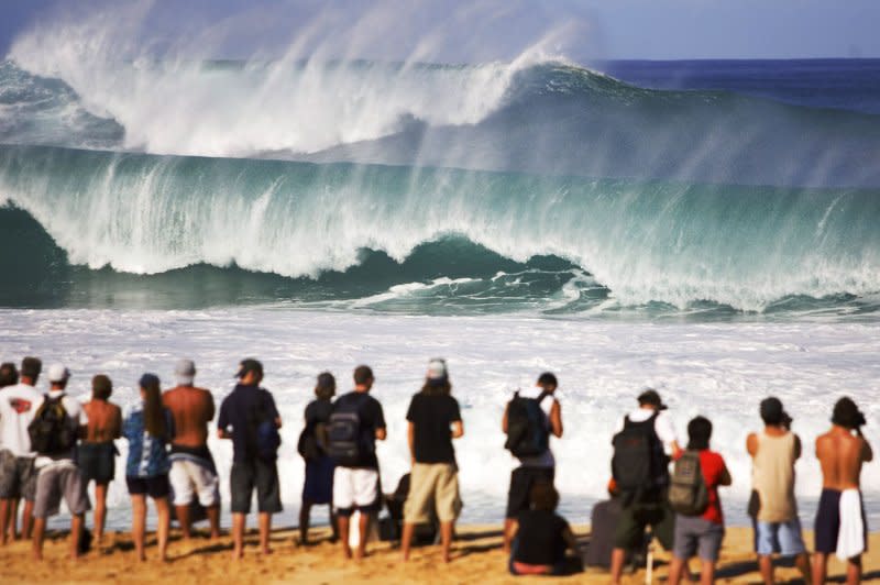 Spectators watch massive waves crash on the North Shore of Oahu, Hawaii, on December 13, 2004. On August 21, 1959, Hawaii became the 50th state of the United States. File Photo by Pierre Tostee/UPI