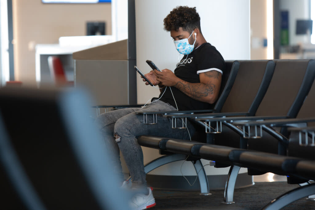 a person wears surgical mask in an airport