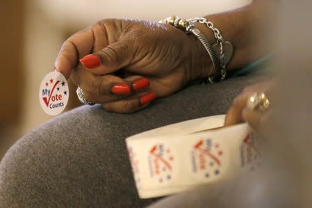 FILE PHOTO: A worker holds stickers for voters at a polling station at the Princeton Baptist Church during the U.S. presidential election, in Princeton, North Carolina