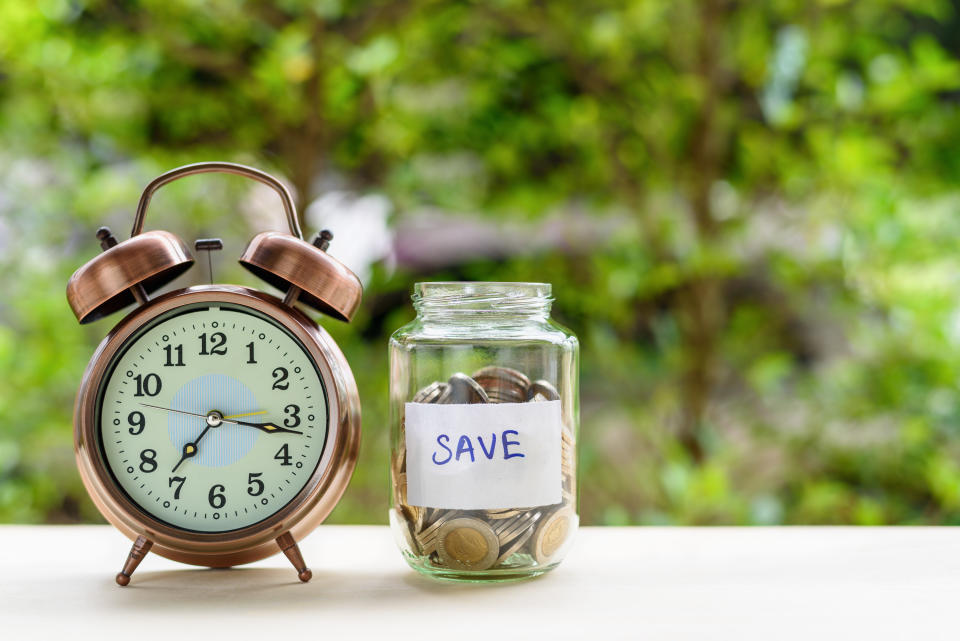 A timepiece and a jar with money