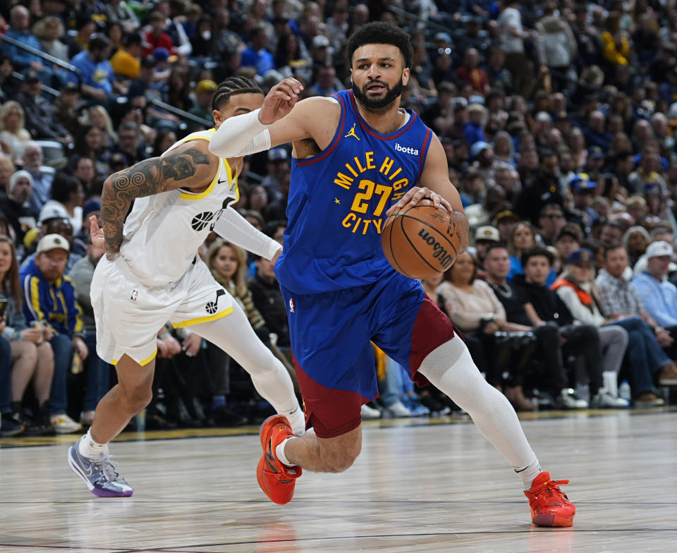 Denver Nuggets guard Jamal Murray, right, drives past Utah Jazz guard Keyonte George during the first half of an NBA basketball game Saturday, March 9, 2024, in Denver. (AP Photo/David Zalubowski)