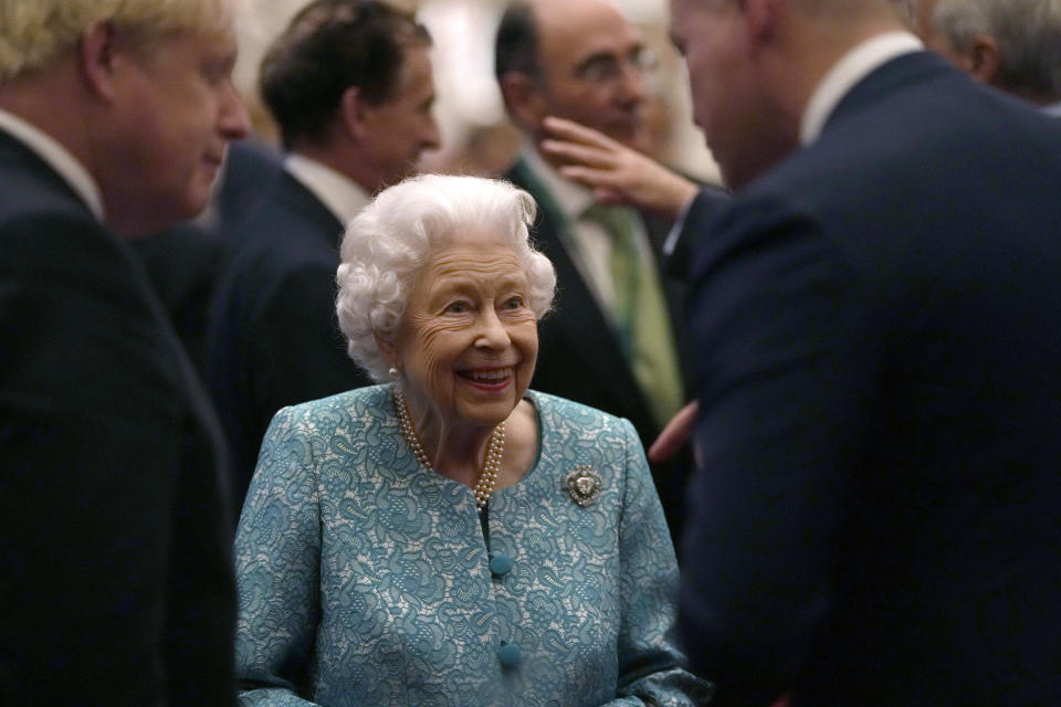 FILE - In this Tuesday, Oct. 19, 2021 file photo, Britain's Queen Elizabeth II and Prime Minister Boris Johnson, left, greet guests at a reception for the Global Investment Summit in Windsor Castle, Windsor, England. Queen Elizabeth II has been advised to rest for at least the next two weeks, accepting doctors’ advice to cut back on her busy schedule, Buckingham Palace said Friday Oct. 29, 2021. (AP Photo/Alastair Grant, Pool, File)