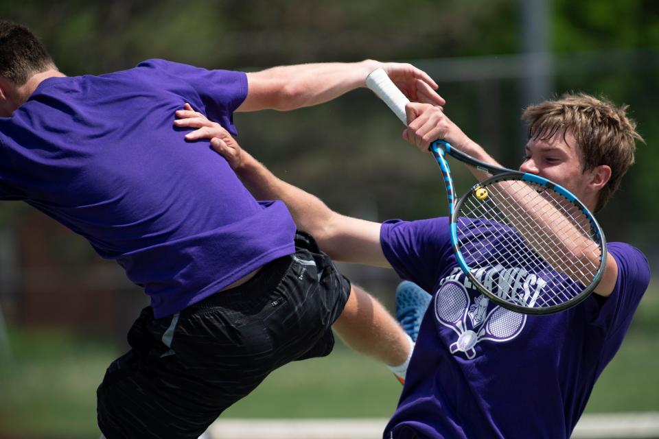 Topeka West Ian Cusick and Miles Cusick celebrate after winning the championship match Saturday at Kossover Tennis Court.