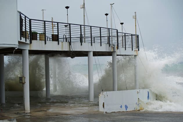 Waves crash against the patio of Lobster Pot restaurant as Hurricane Ian passes through George Town, Grand Cayman island, on Monday. (Photo: Kevin Morales via Associated Press)