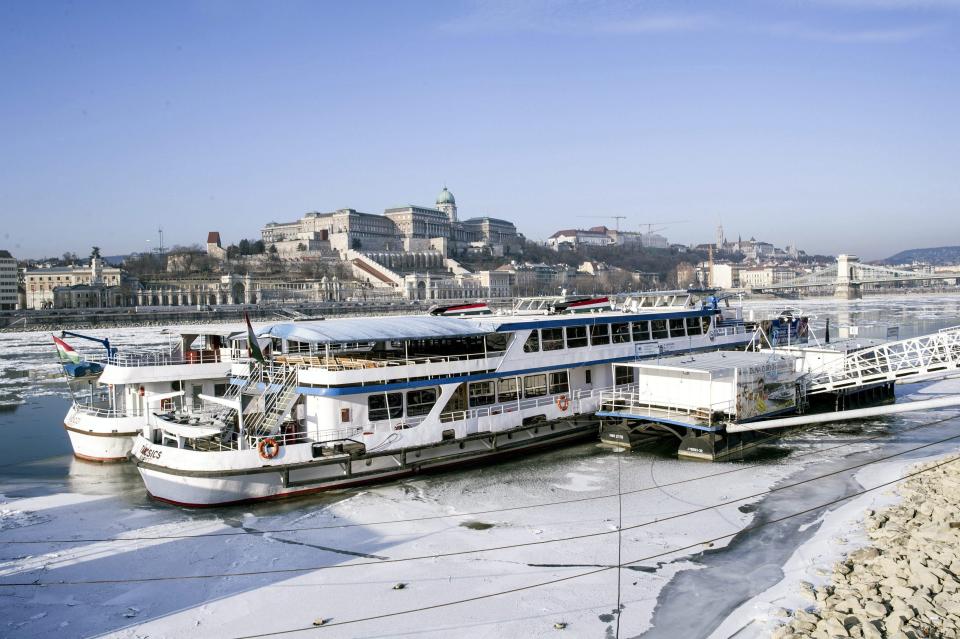 Moored riverboats are stuck on the Pest side embankment of the frozen River Danube in Budapest, Wednesday, Jan. 11, 2017. The transport department of the metropolitan government office banned shipping on the Danube and the ferry traffic is also halted in the Hungarian capital. (Bea Kallos/MTI via AP)