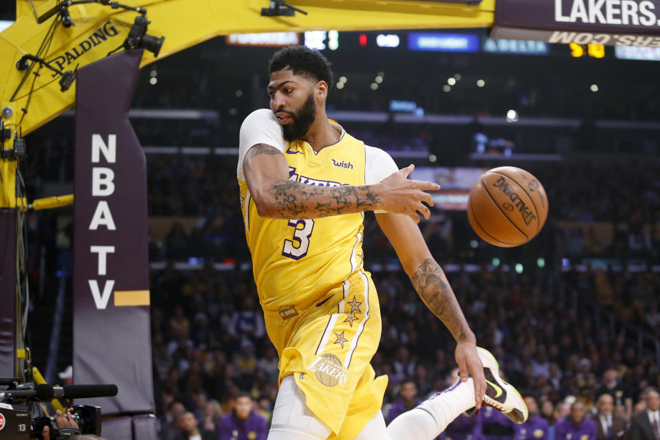 Los Angeles Lakers' Anthony Davis keeps the ball in play during the first half of the team's NBA basketball game against the Los Angeles Clippers, Wednesday, Dec. 25, 2019, in Los Angeles. (AP Photo/Ringo H.W. Chiu)
