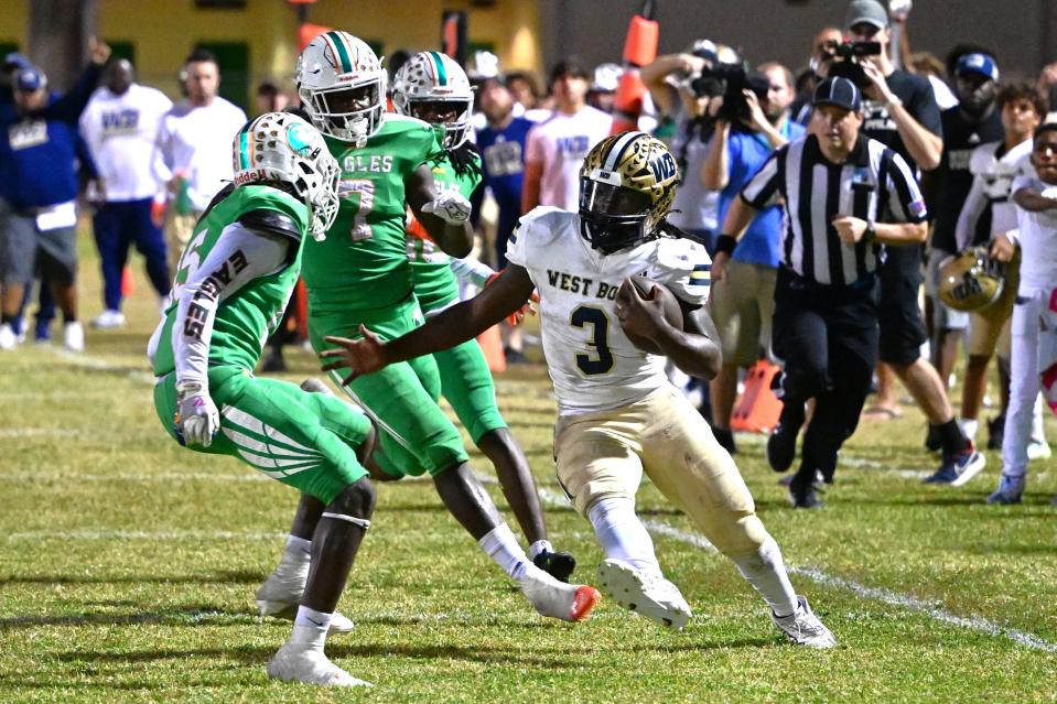 West Boca's Javian Mallory jukes last line of the Eagles' defense before taking it in for six on Nov. 10, 2023.