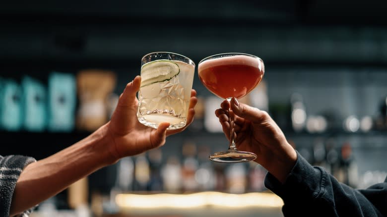 People clinking cocktail glasses