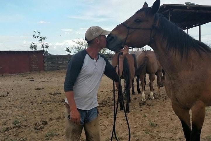 Jim Dewey Brown is pictured with his horse Roanie, the original Keystone at New Mexico State University.