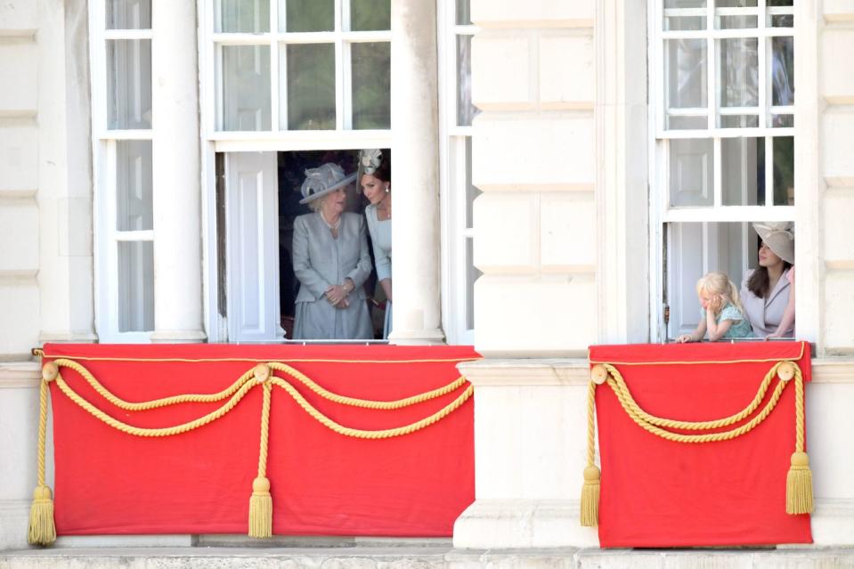 <p>The Duchess of Cornwall and the Duchess of Cambridge share a moment before heading onto the balcony for the RAF flyover. Isla Phillips, granddaughter of Princess Anne, can also be spotted peering out at the crowds.</p>