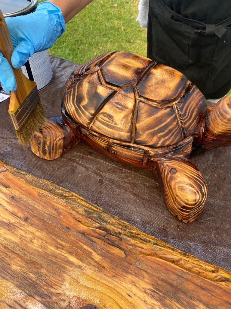 Image description: a freshly-carved and glazed turtle in homage to Monterey County.