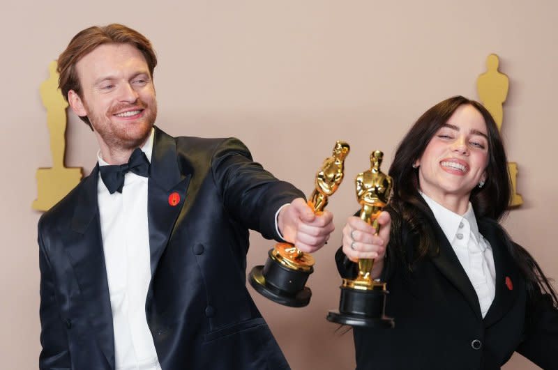 Billie Eilish and Finneas O'Connell both wore red pins to the Oscars on Sunday. Photo by Pat Benic/UPI