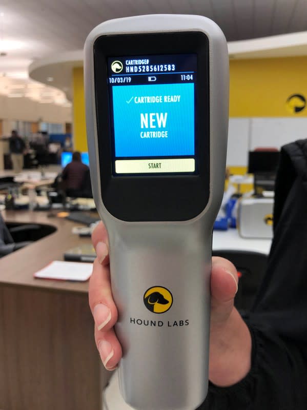 A Hound Labs employee holds a pre-commercial prototype of the company's marijuana breathalyzer, which it says can detect minuscule amounts of THC on a user's breath, in Newark