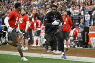 NFC cornerback Trevon Diggs of the Dallas Cowboys, right, runs with the ball after intercepting a pass off his brother, AFC wide receiver Stefon Diggs of the Buffalo Bills, left, during the flag football event at the NFL Pro Bowl, Sunday, Feb. 5, 2023, in Las Vegas. (AP Photo/David Becker)