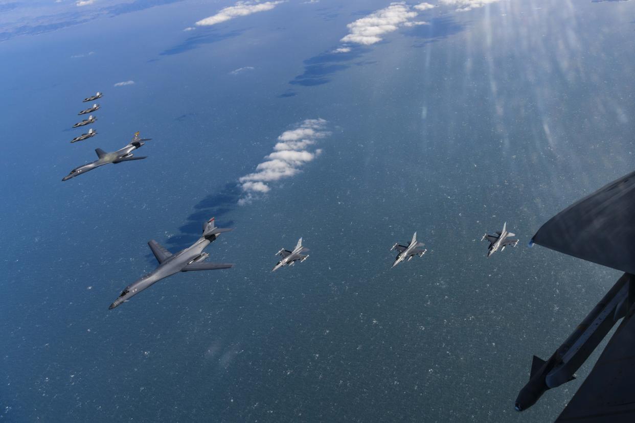 In this photo provided by South Korea Defense Ministry, U.S. Air Force B-1B bombers fly in formation with South Korea's Air Force F-35A fighter jets and US Air Force F-16 fighter jets over the South Korea Peninsula during a joint air drill in South Korea, Sunday, Feb. 19, 2023. (South Korea Defense Ministry via AP)