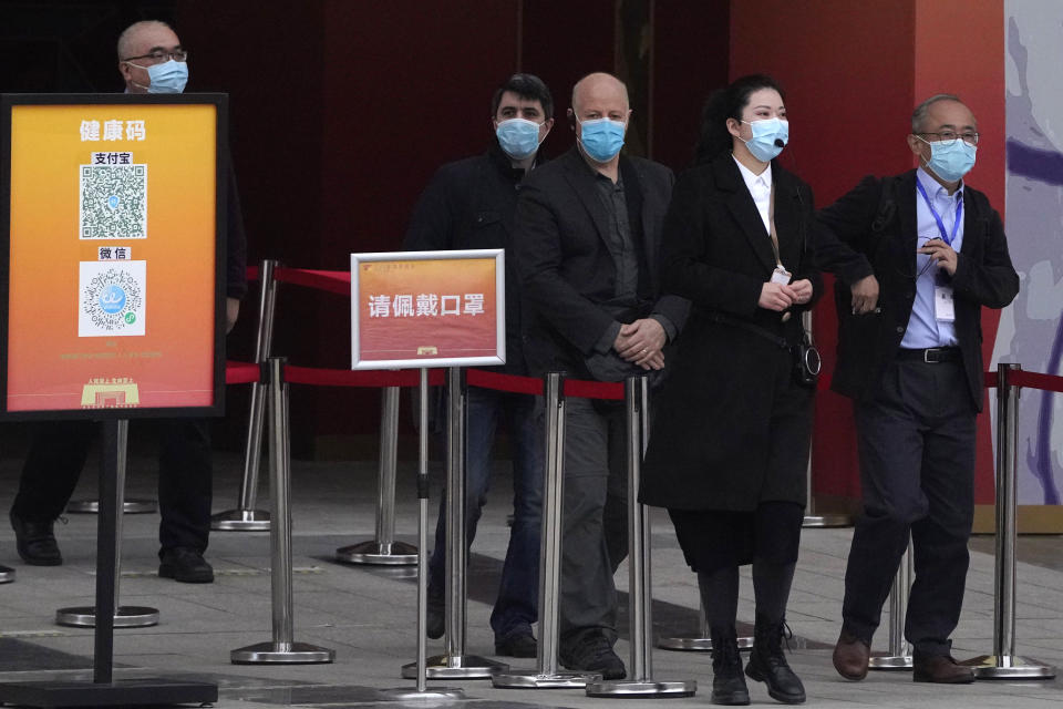 Members of the World Health Organization team including Ken Maeda, right, Peter Daszak, third from right and Vladmir Dedkov, second from left leave after attending an exhibition about the fight against the coronavirus in Wuhan in central China's Hubei province on Saturday, Jan. 30, 2021. The World Health Organization team investigating the origins of the coronavirus pandemic visited another Wuhan hospital that had treated early COVID-19 patients on their second full day of work on Saturday. (AP Photo/Ng Han Guan)