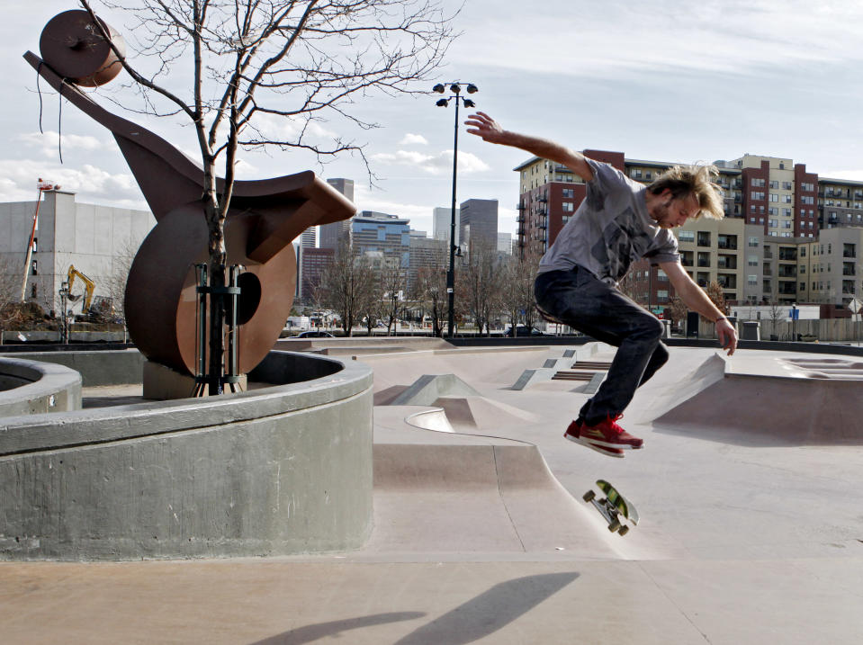 This photo taken on Dec. 7, 2012 shows Brian Knapp, 22, doing a trick on his skate board at Denver's Skateboard Park. The park is one of the premiere parks of its kind in the country, featuring 60,000 square feet of skateable concrete terrain. Use of the park is free, but you have to bring your own gear or rent it from nearby shops. (AP Photo/Ed Andrieski)