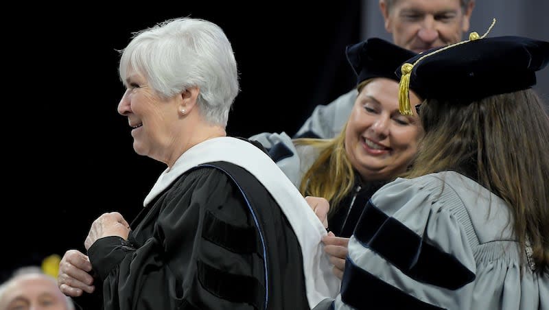 Gail Miller receives a honorary doctoral degree during the commencement ceremony at Utah State University on Thursday, May 2, 2024.