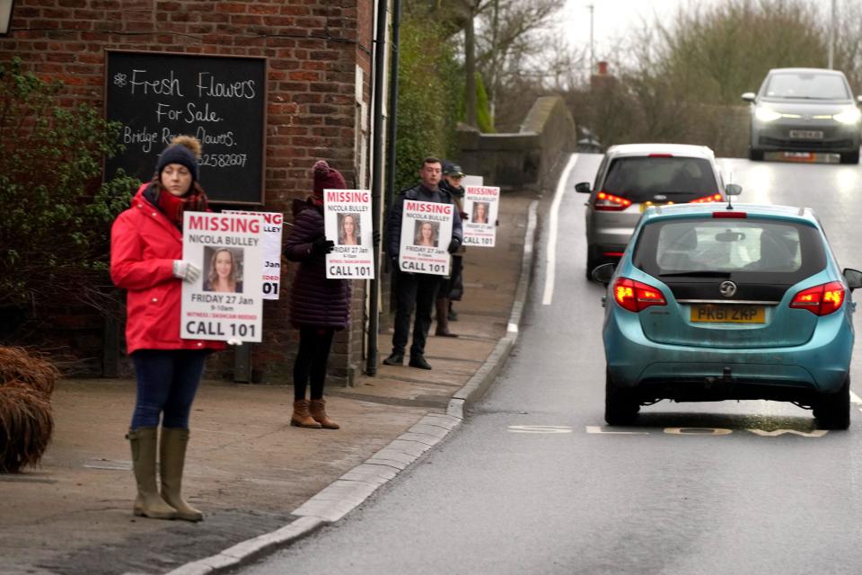 Friends of missing woman Nicola Bulley hold missing person appeal posters along the main road in the village in St Michael's on Wyre, Lancashire. Ms Bulley, 45, was last seen two weeks ago on the morning of Friday January 27, when she was spotted walking her dog on a footpath by the nearby River Wyre. Picture date: Friday February 10, 2023.