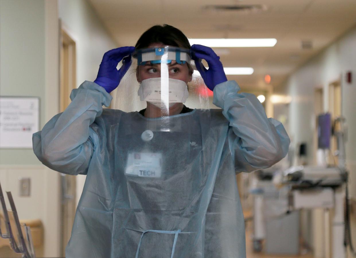 Fawn Huff, a multi-skill technician, has on a mask and a face shield before entering a patient's room on Aug. 17, 2021 at Mount Carmel St. Ann's in Westerville.  The four major Columbus-area health care systems will by the end of this week end mask mandates at their facilities except for places like cancer wards or transplant areas.