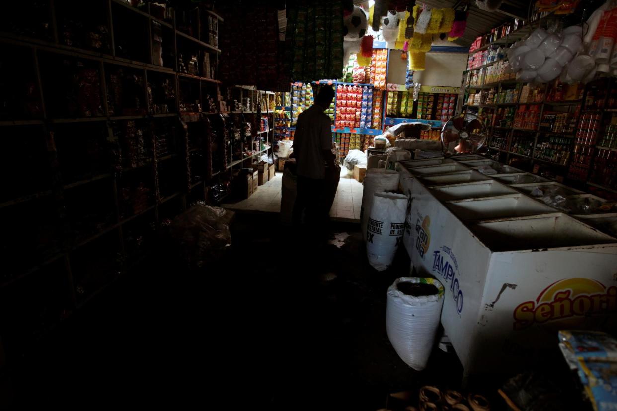 A man is silhouetted in a shop during a massive power outage in Tegucigalpa, Honduras: REUTERS